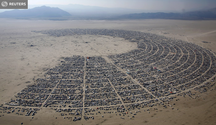 An aerial view of the Burning Man 2013 arts and music festival in the Black Rock Desert of Nevada, August 29, 2013. The federal government issued a permit for 68,000 people from all over the world to gather at the sold out festival, which is celebrating its 27th year, to spend a week in the remote desert cut off from much of the outside world to experience art, music and the unique community that develops. REUTERS/Jim Urquhart (UNITED STATES) FOR EDITORIAL USE ONLY. NOT FOR SALE FOR MARKETING OR ADVERTISING CAMPAIGNS. NO THIRD PARTY SALES. NOT FOR USE BY REUTERS THIRD PARTY DISTRIBUTORS. FOR USE WITH BURNING MAN RELATED REPORTING ONLY