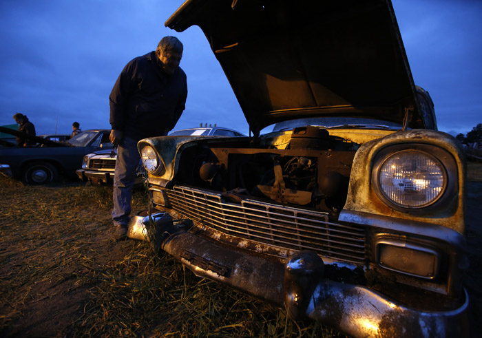 Marty Zabel checks out the vintage a 1956 Chevrolet from the Lambrecht Collection before being put up for auction in Pierce, Nebraska, September 28, 2013. Over 500 classic cars and trucks from an inventory collected by Ray and Mildred Lambrecht will be sold over the weekend. REUTERS/Jim Urquhart (UNITED STATES)