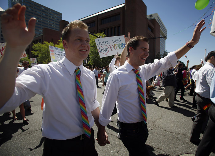 Members of the Mormon church who are gay Michael Twede, left, and Spencer Smith hold hands as they march in a gay pride parade in Salt Lake City, Utah, June 2, 2013. Both active Mormons and members of the Boy Scouts marched with members of LGBT community and their supporters as part of the Utah Pride Festival. REUTERS/Jim Urquhart (UNITED STATES)